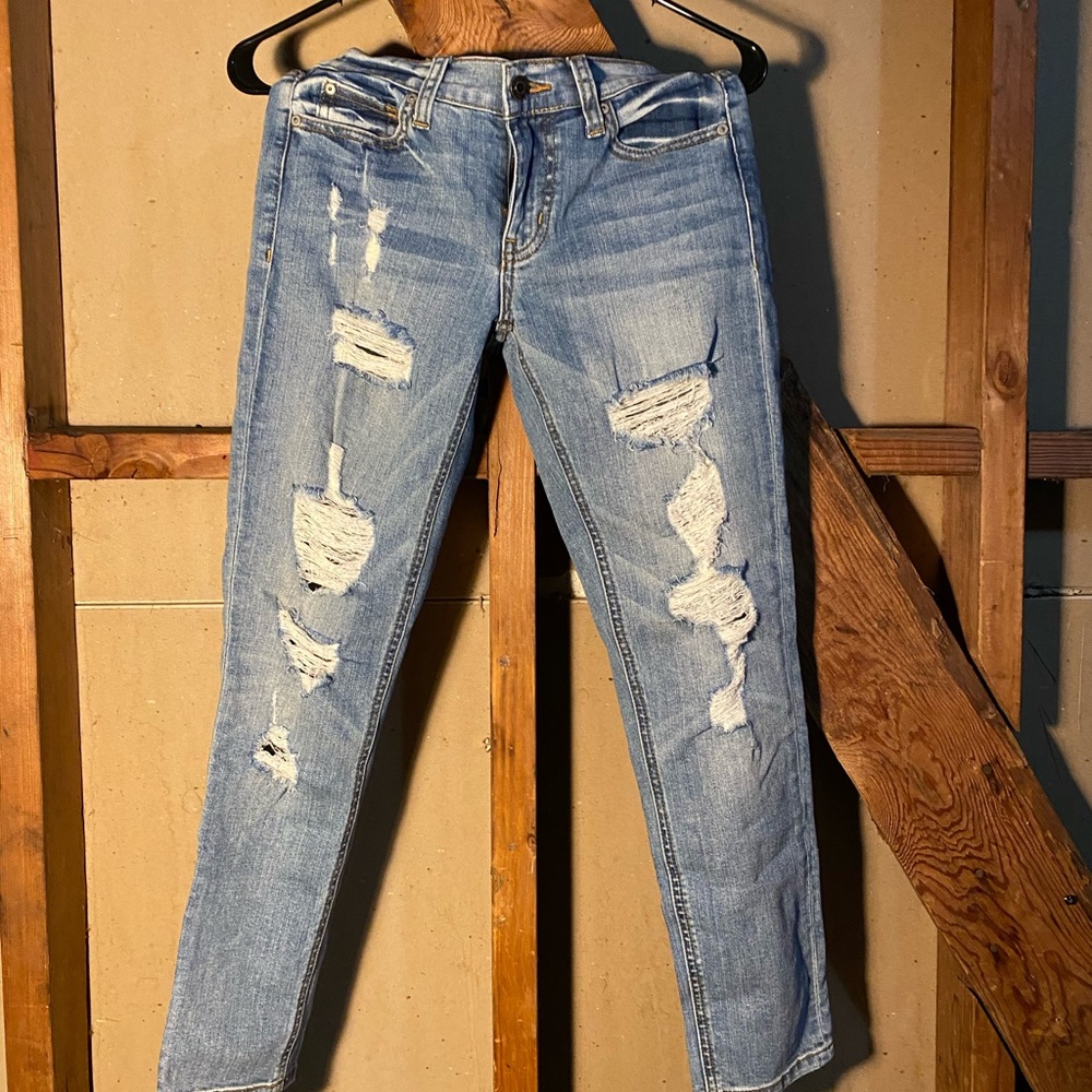 Tight, skinny ripped dark blue jeans